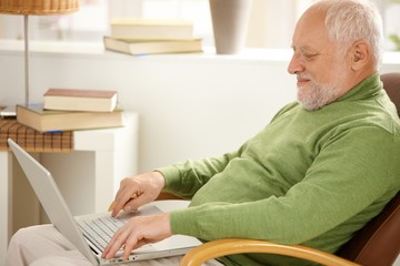 Sticker - Smiling pensioner using laptop computer