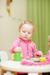 Canvas Print - Little girl playing with toys