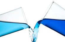 Two Glasses Spilling Water Or A Similar Blue Liquid Isolated On