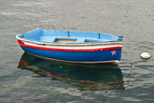 Small, Blue Rowboat Moored In A Marina