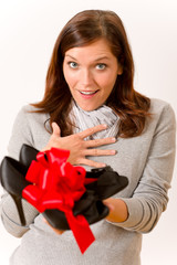 Surprised woman holding present shoes