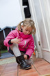 © gemenacom - Little girl tying her shoes