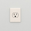 Electrical outlet over white wall
