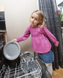 © gemenacom - Young Girl by the Dishwasher