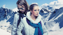 Fashionable couple over alpine mountains