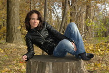 Girl Sitting On A Stump