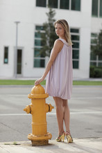 Woman Posing By A Fire Hydrant In The City
