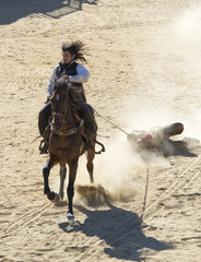 Fototapete - Deputy Sheriff dragging a bandit by a rope off his horse