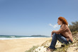 © mangostock - pensive woman sitting on the dunes