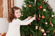 Little girl decorating the Christmas tree