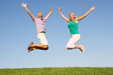 Senior Couple Jumping In Air
