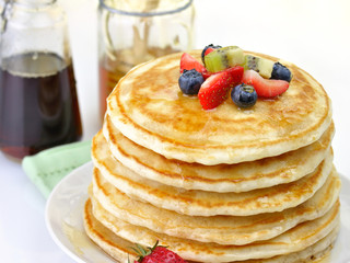 Wall Mural - stack of pancakes with maple syrup,honey and berries