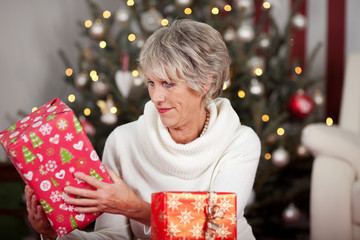 Sticker - seniorin mit weihnachtsgeschenk vor dem weihnachtsbaum