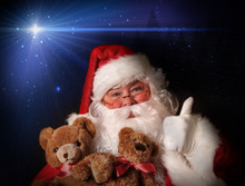 Santa Smiling Holding Toy Teddy Bears