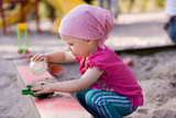 little girl in sandbox