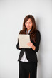© goodluz - Businesswoman standing in hall with electronic pad