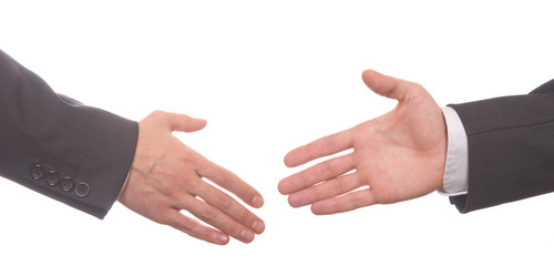 Closeup of business people shaking hands over white