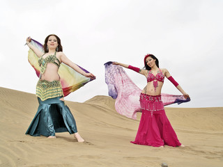 Two arabic dancers holding clothes