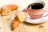 Fototapeta Mapy - breaking croissant with coffee