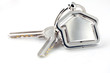 Two silver keys with metal house figure