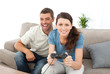 © WavebreakMediaMicro - Portrait of a woman playing video game with her boyfriend