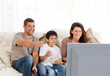 © WavebreakMediaMicro - Family laughing while watching television together
