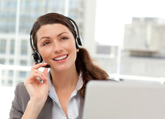 Thoughtful businesswoman talking on the phone with earpiece