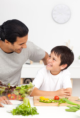 Wall Mural - Happy father helping his son in the kitchen