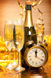 Happy New Year - Bottle of champagne, two glasses and alarm clock as a symbol of New Year's fun