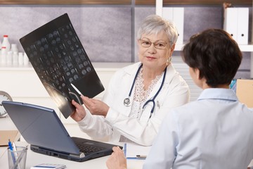 Wall Mural - Doctor showing x-ray results to patient