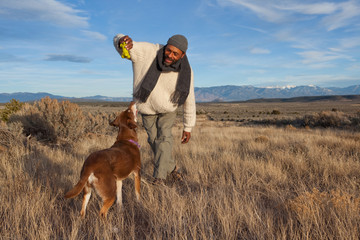 Man playing with his dog