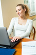 © vgstudio - Young happy woman working with laptop, at home