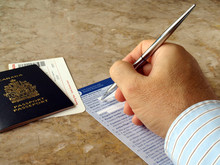 Man Filling Out U.S. Customs And Border Form