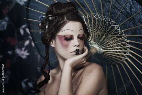 Fototapeta na wymiar portrait of a beautiful white girl in geisha style