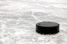 Black Hockey Puck On Ice Rink