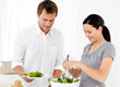 © WavebreakMediaMicro - Happy woman serving salad to his boyfriend for the lunch