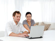 © WavebreakMediaMicro - Happy man and woman looking at something on the laptop