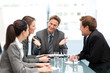 © WavebreakMediaMicro - Delighted managertalking to his team at a table