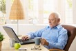 © nyul - Elderly man using computer, having coffee