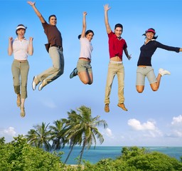 Jumping young people happy group tropical beach