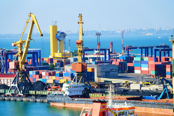 The trading seaport with cranes, cargoes and ship