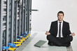 © .shock - business man practice yoga at network server room