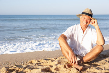 Senior man sitting on beach relaxing