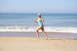 © Monkey Business - Senior woman running on beach