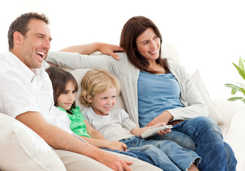 Happy family watching television together