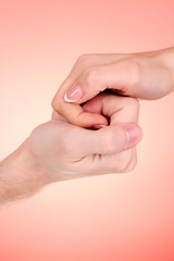 Wall Mural - Couple of hands snatcing each other on red background