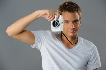 Wall Mural - Young man with a camera