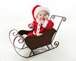 © blessings - Smiling santa baby sitting in a sleigh