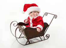 Santa Baby Sitting In A Sleigh