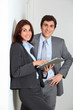 © goodluz - Business people using electronic tab